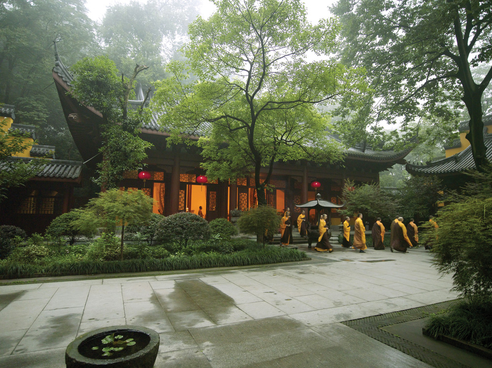 Monks leave a Buddhist temple next to Amanfayun in Hangzhou, China